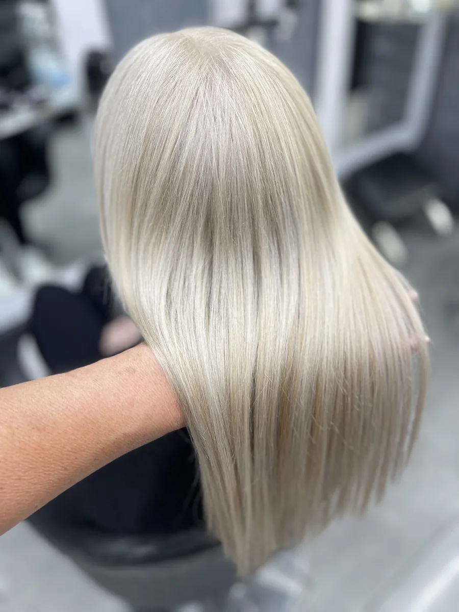 Long poker-straight icy platinum blonde blow-dry seen from behind